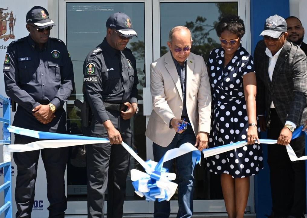 Deputy Prime Minister and Minister of National Security, the Hon. Dr Horace Chang cuts the ribbon to officially declare the newly constructed Lacovia Police Station in St. Elizabeth open. Commanding Officer for the Division Superintendent Coleridge Minto (1st left), Police Commissioner Dr Kevin Blake (2nd left), Permanent Secretary Ambassador Alison Stone Roofe and North East St. Elizabeth Member of Parliament Delroy Slowley, were also on hand to participate in the exercise.