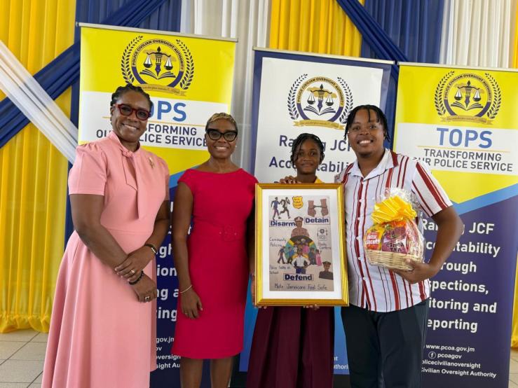 Minister of State in the Ministry of National Security and Peace, the Hon. Juliet Cuthbert-Flynn (second left) and Permanent Secretary in the Ministry, Ambassador Alison Stone Roofe (left) share a moment with (l-r) 2nd place winner of the Transforming Our Police Service (TOPS) Competition in the poster category, Jisselle Wallace and teacher at the Spanish Town High School, Mr. Tyrone Rowe. The competition was organised by the Police Civilian Oversight Authority with the award ceremony held on Thursday (Dece