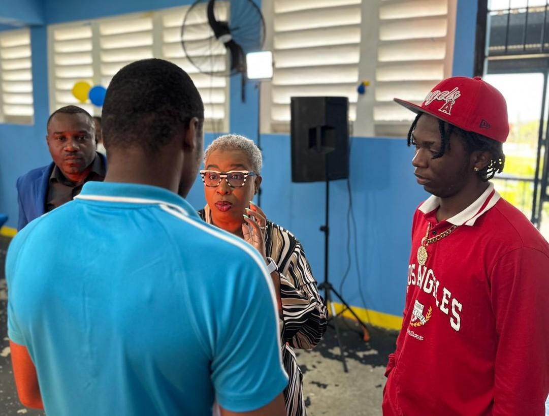 Acting Director of Community Cultural Development Services at the Jamaica Cultural Development Commission (JCDC), Dr. Andrea McCurdy (second right), encourages a ward who participated in the LIV GUD Jingle Competition at the Metcalfe Street Secure Juvenile Centre on February 12. Competition judges, recording artiste and dancer, Omario ‘Kaka Highflames’ Brown (right), and Sergeant Ricardo McCalpin (left), of the Jamaica Constabulary Force, look on.