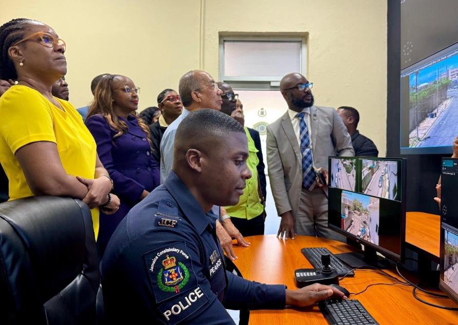 Deputy Prime Minister and Minister of National Security, the Hon. Dr Horace Chang, Member of Parliament for Kingston Western, Desmond McKenize (partly hidden), Permanent Secretary in the Ministry of National Security, Ambassador Alison Stone Roofe (left) and Senior Director for the Major Technology Transformation Branch in the Ministry of National Security, Emil Holgate as well as Chairman of the Jamaica Police Federation, Sergeant Arleen McBean (centre) view the CCTV screens as Corporal Alex Pearce explain