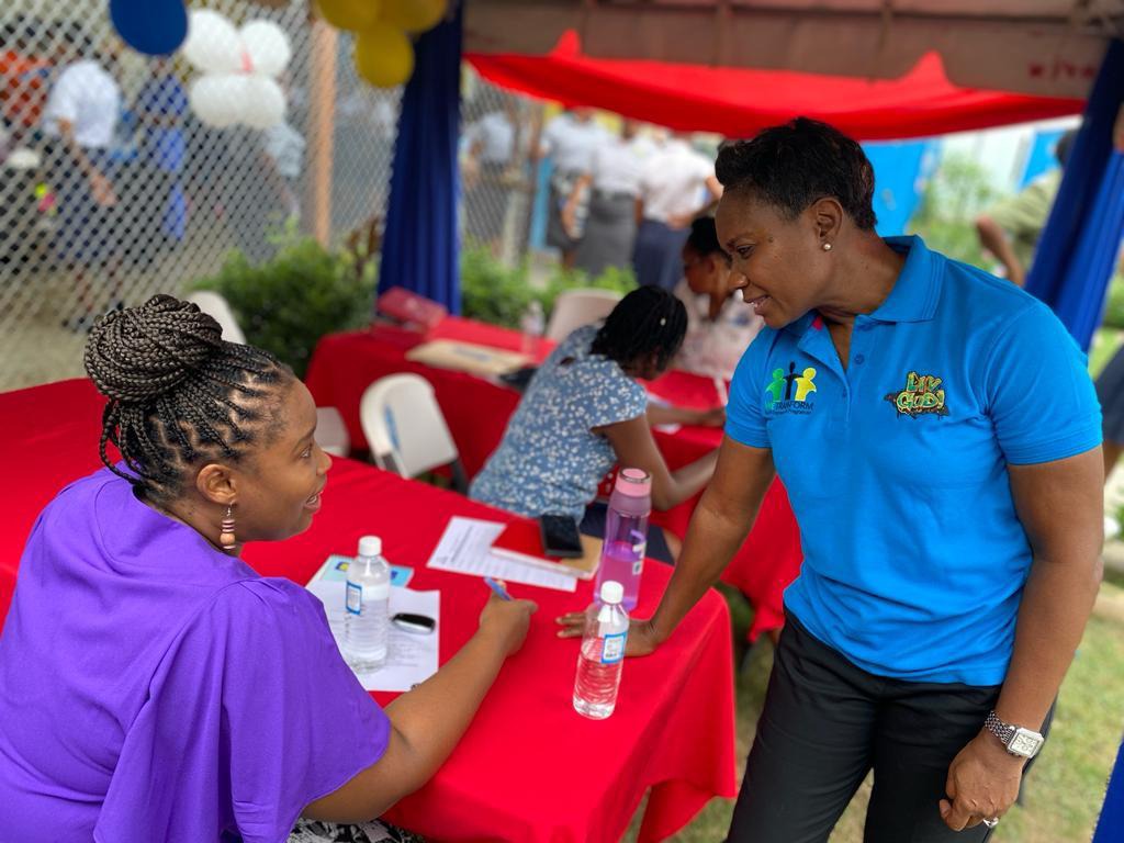 Minister of State in the Ministry of National Security Hon. Juliet Cuthbert-Flynn in conversation with ___ at the We Transform Youth and Parent Lynk-Up Reintegration Day held at the South Camp Juvenile Correctional and Remand Center today (November 23).