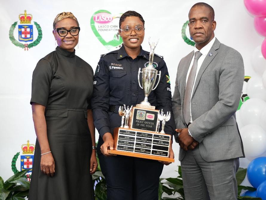Minister of State in the Ministry of National Security and Peace, the Hon. Juliet Cuthbert-Flynn (left) and Commissioner of Police, Dr. Kevin Blake, share the spotlight with the 2025 LASCO Chin Foundation Top Cop, Constable Shantel Powell of Area 5. Constable Powell was announced the winner at the 25th staging of the Saluting Our Heroes Awards Ceremony on Wednesday, December 17, 2025 at the Jamaica Pegasus Hotel in Kingston.