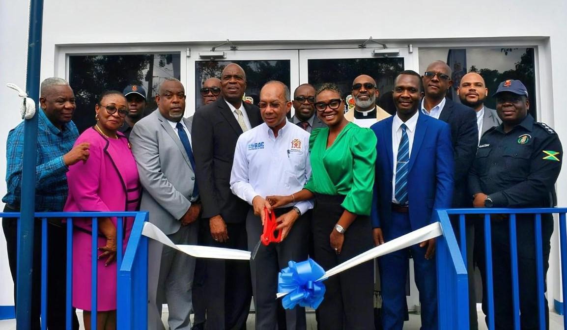 Deputy Prime Minister and Minister of National Security, the Hon. Dr Horace Chang (centre) is rd supported by Minister of State, the Hon. Juliet Cuthbert Flynn (3 left) in cutting the ribbon to officially open the newly constructed Stony Hill Police Station, on Wednesday, July 30. Also photographed are Chief Technical Director in the Ministry of National Security, Mr. Delroy Simpson nd (2 left), representatives from the National Housing Trust and members of the Jamaica Constabulary Force, the community and 