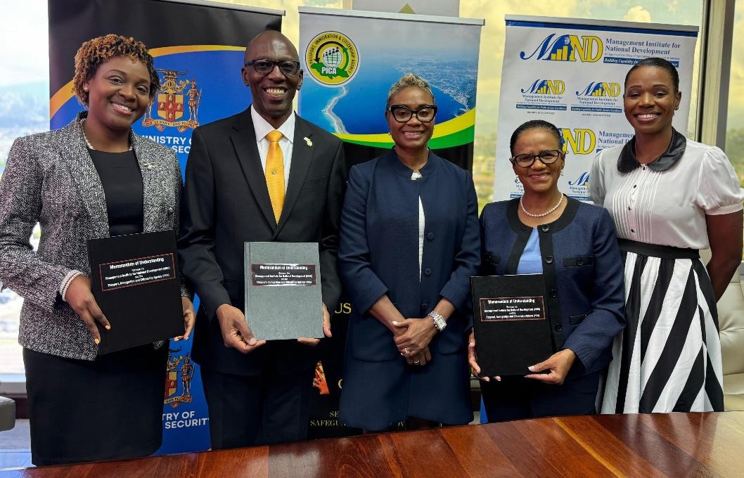Minister of State in the Ministry of National Security and Peace, the Hon. Juliet Cuthbert-Flynn (centre), is flanked by Chief Executive Officer, Passport Immigration and Citizenship Agency (PICA), Mr. Garth Williams (second left), Chief Executive Officer, Management Institute for National Development (MIND), Dr. Ruby Brown (second right), Director Public Service Capability Development at MIND, Mrs. Natasha Gordon-Miller (left) and MIND’s Director Business Development and Communications, Mrs. Prudence James
