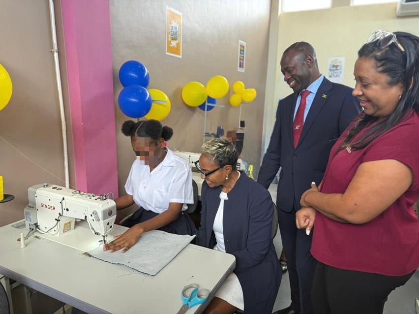 Minister of State in the Ministry of National Security and Peace, the Hon. Juliet Cuthbert-Flynn (seated, second left), looks on as a ward at the South Camp Juvenile Correctional and Remand Centre operates one of the new sewing machines in the sewing laboratory which was officially handed over to the correctional centre on Thursday (March 12). Also looking on are Commissioner of Corrections, Brigadier (Ret’d) Radgh Mason (second right) and Chief Executive Officer at the Digicel Foundation, Ms. Charmaine Dan