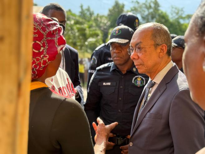 Deputy Prime Minister and Minister of National Security and Peace, Hon. Dr. Horace Chang (right) and Commissioner of Police, Dr. Kevin Blake (centre), listen as a resident of the Commodore in Linstead, St. Catherine, recalls the horrific attack on the community that claimed the lives of 5 residents on Sunday, October 5. The Prime Minister and the Deputy Prime Minister visited the community on Monday, October 6, with members of the security forces to reassure the residents that the perpetrators will be broug