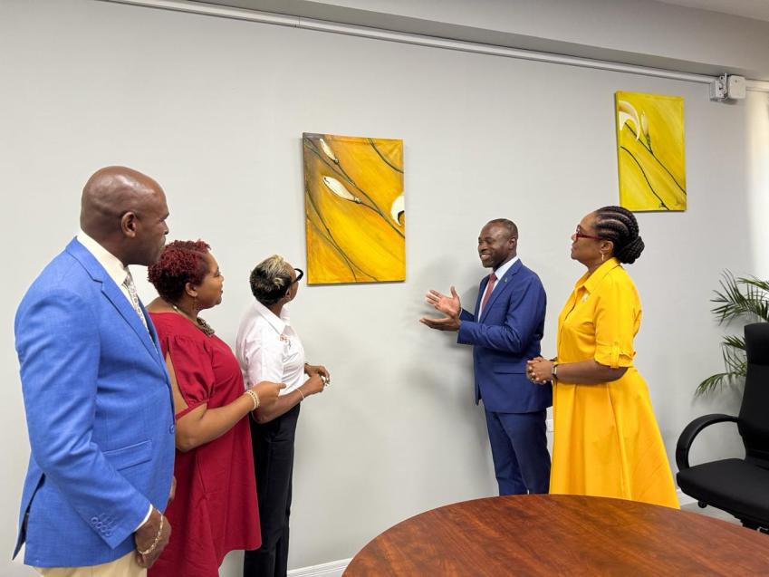 Minister of State in the Ministry of National Security and Peace, the Hon. Juliet Cuthbert-Flynn (centre), admires artwork being shown by Commissioner of Corrections, Brigadier (Ret’d) Radgh Mason (2nd right) at the newly opened Probation Office in Montego Bay, St. James during a tour of the facility on Friday, March 13, 2026. Also admiring the artwork created by inmates in the correctional system are Permanent Secretary in the Ministry, Ambassador Alison Stone Roofe (right), Director, Probation Aftercare, 