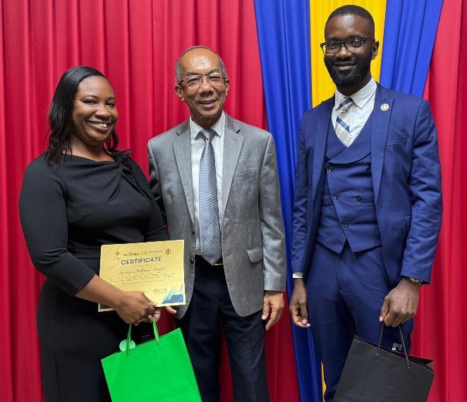Deputy Prime Minister and Minister of National Security and Peace, the Hon. Dr. Horace Chang congratulates Inspector Jodeann Williams-Scarlett of the Planning, Research and Development Branch (left), and Corporal Javon Henry of the Corporate and Special Services Branch of the Jamaica Constabulary Force, for successfully completing the Integrated Research Methods Course at the University of the West Indies, Mona. The two joined twenty-eight other successful police officers at Thursday’s (April 30) graduation