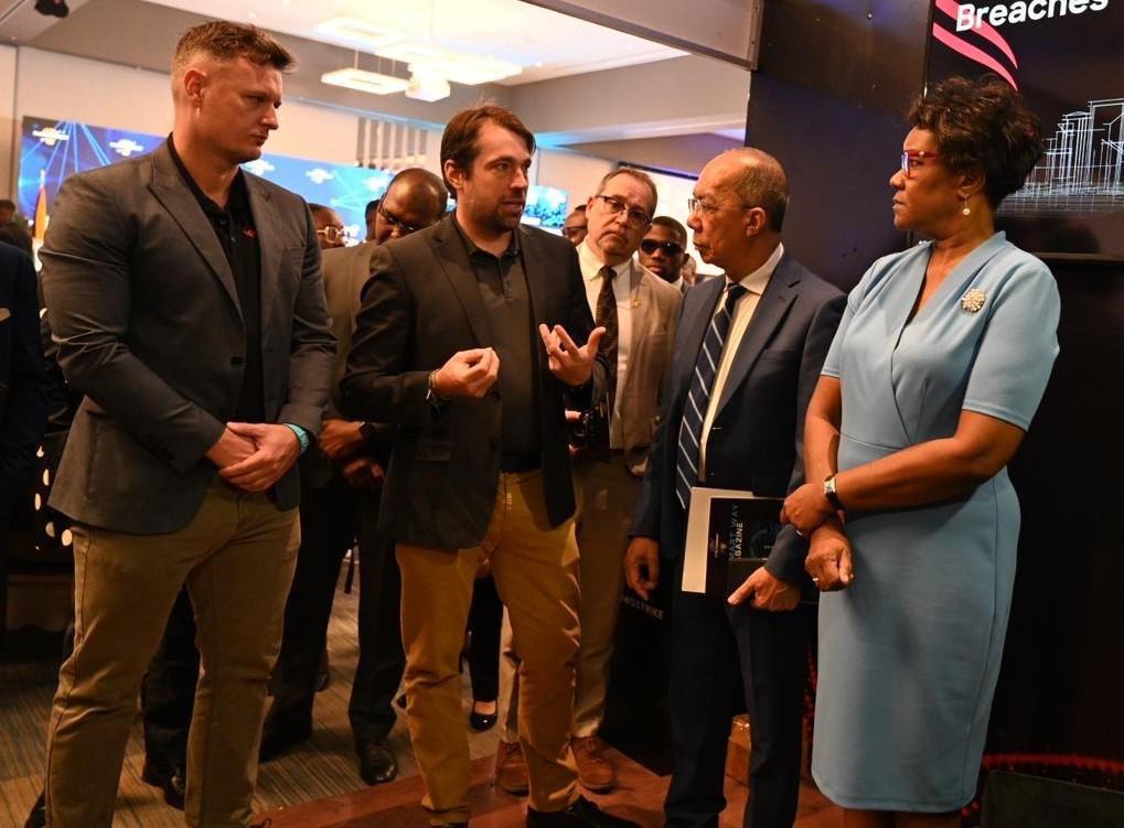 Deputy Prime Minister and Minister of National Security, the Hon. Dr Horace Chang (2nd right), Permanent Secretary in the Ministry of National Security, Ambassador Alison Stone Roofe and Caribbean Corporate Accounts Executive at CrowdStrike, Ted Cheavens Jnr. (left), engage in conversation with CrowdStrike’s Regional Sales Manager for the English-speaking Caribbean, Christian Nanne (centre), during the opening session of the Inaugural Ministry of National Security CyberSmart Conference. The event is being h