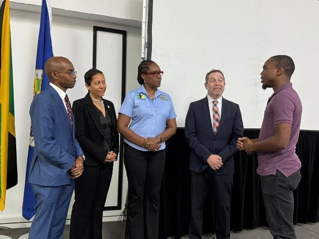 Permanent Secretary in the Ministry of National Security and Peace, Ambassador Alison Stone Roofe (centre), alongside Permanent Security in the Office of the Prime Minister, Ambassador Dr. Rocky Meade (left), Canadian High Commissioner to Jamaica, His Excellency Mark Berman (2nd right) and Country Representative of the Organization of American States, Jeanelle van GlaanenWeygel (2nd left), discuss expected outcomes of the cybersecurity training with programme participant, Brandon Hibbert, at the Opening Cer