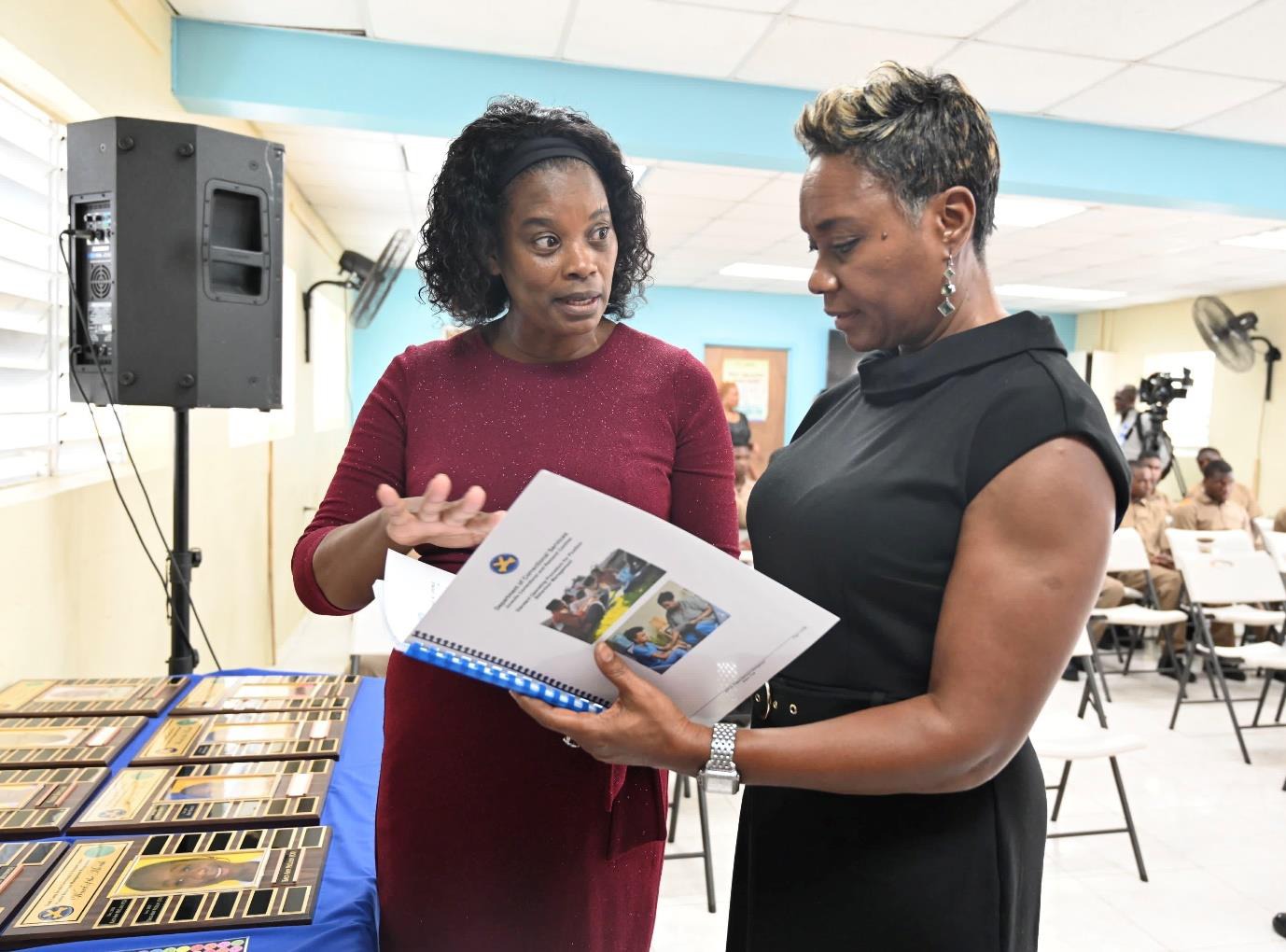 Minister of State in the Ministry of National Security, the Hon. Juliet Cuthbert-Flynn (right) engages in a conversation about the Positive Behaviour Management Standard Operating Procedures (SOP) Manual with Director of Juvenile Services, Claudeth Hamilton at the launch event for the Manual at the Rio Cobre Juvenile Correctional Centre yesterday (March 13).