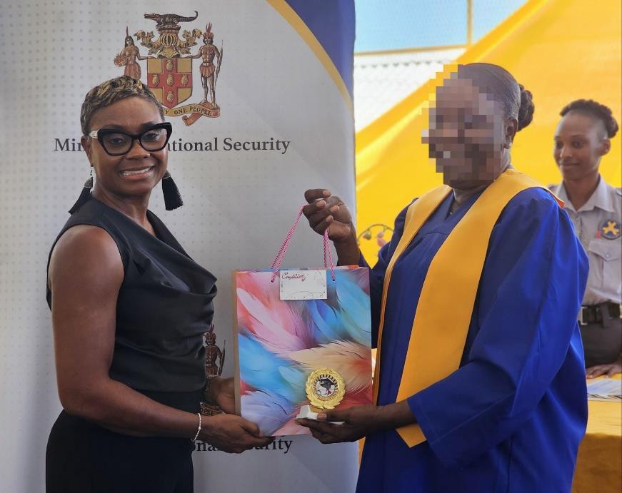 Minister of State in the Ministry of National Security, the Hon. Juliet Cuthbert-Flynn shares a moment with one of the forty-four (44) inmates at the South Camp Adult Correctional Centre who successfully completed training in Customer Service, Dancehall and Theatre through partnership with the HEART/NSTA Trust. The graduation ceremony was held today (March 20) at the institution.