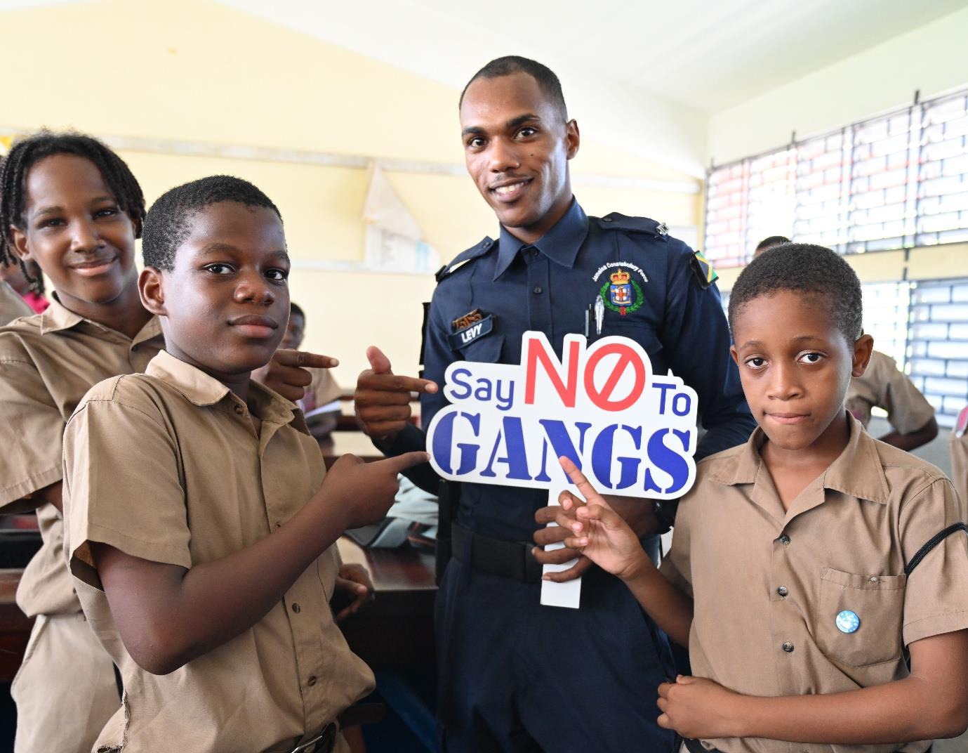 Constable Andrae Levy of the Community Safety and Security Branch in the Jamaica Constabulary Force (JCF) sends a clear message with students at the Albion Primary and Junior High School on October 11, 2024 following a session on conflict resolution. The session was the second stop of the LIV GUD School Invasion, which resumed in September.