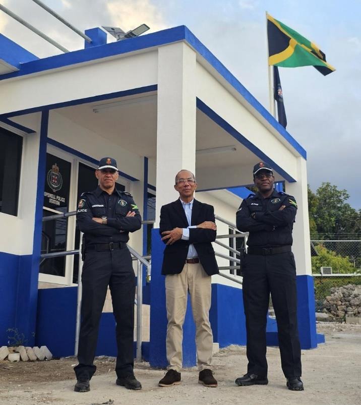 Deputy Prime Minister and Minister of National Security, the Hon. Dr. Horace Chang(centre), outgoing Commissioner of Police, Major General Antony Anderson (left) and Commissioner-designate, Dr. Kevin Blake (right) pose at the entrance of the newly built Hopewell Police Station in Hanover after the Opening Ceremony yesterday (March 15).
