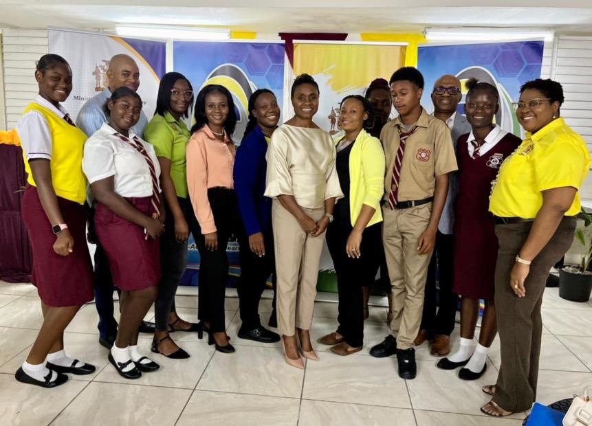 Minister of State in the Ministry of National Security, the Hon. Juliet Cuthbert-Flynn shares a moment with Chief Technical Director in the Ministry of National Security, Shauna Trowers and Case Management officers at the handover ceremony for ninety (90) tablets donated by e-Learning Jamaica to students under the Inter-Ministerial School Support Strategy. The handover ceremony was hosted at Denham Town High School, one of the thirty-four (34) schools located in, or served by the seven Zones of Special Oper