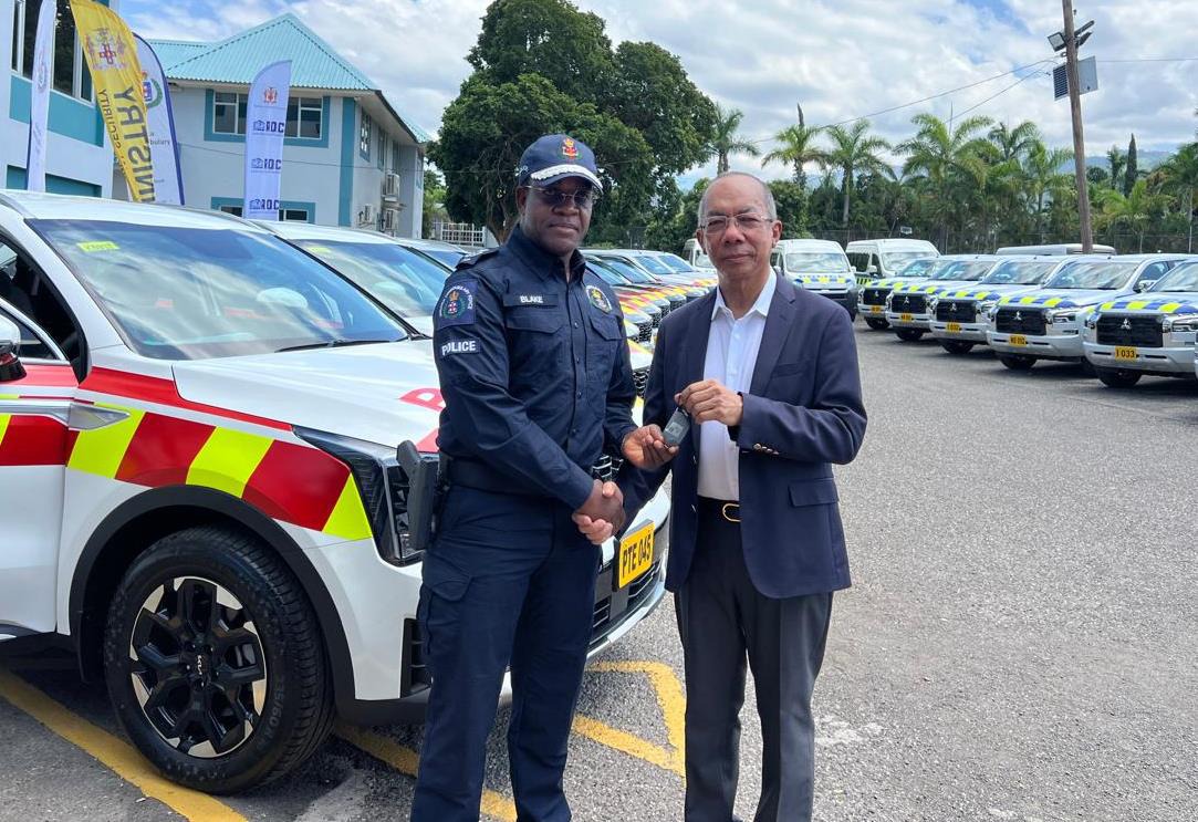 Deputy Prime Minister and Minister of National Security, the Hon. Dr. Horace Chang, symbolically presents the Commissioner of Police Dr. Kevin Blake with a key to one of the forty new police vehicles at the handing over ceremony earlier today (July 31) at Commissioner’s office.