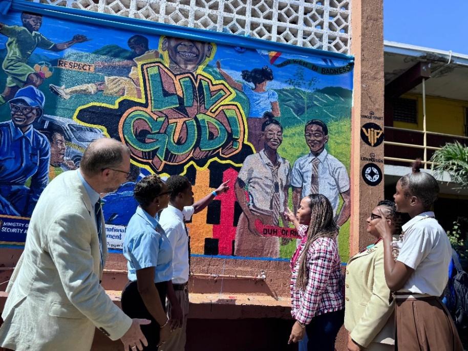 Minister of State in the Ministry of National Security and Peace, Hon. Juliet Cuthbert-Flynn (2nd left), looks on as Permanent Secretary in the Ministry of Education, Youth, Skills and Information, Dr. Kasan Troupe (3rd right) and Head Boy of the Haile Selassie High School, Jahiem Pinnock (3rd left) reflect on the bold messages of the LIV GUD Anti-violence Campaign mural at the school on Friday, February 13. The mural was unveiled along with a Wellness Express as part of the government’s pledge to providing