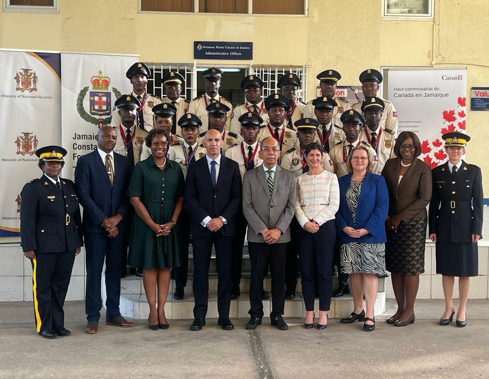 Deputy Prime Minister and Minister of National Security, the Hon. Dr. Horace Chang (centre), Permanent Secretary in the Ministry of National Security, Ambassador Alison Stone Roofe (second left), Commissioner of Police, Major General Antony Anderson (first left), High Commissioner of Canada to Jamaica, Her Excellency Emina Tudakovic (second right) and other senior officials pose for a photo at the Closing Ceremony for sixteen (16) members of the Haitian National Police (HNP) Training Course held at the Nati