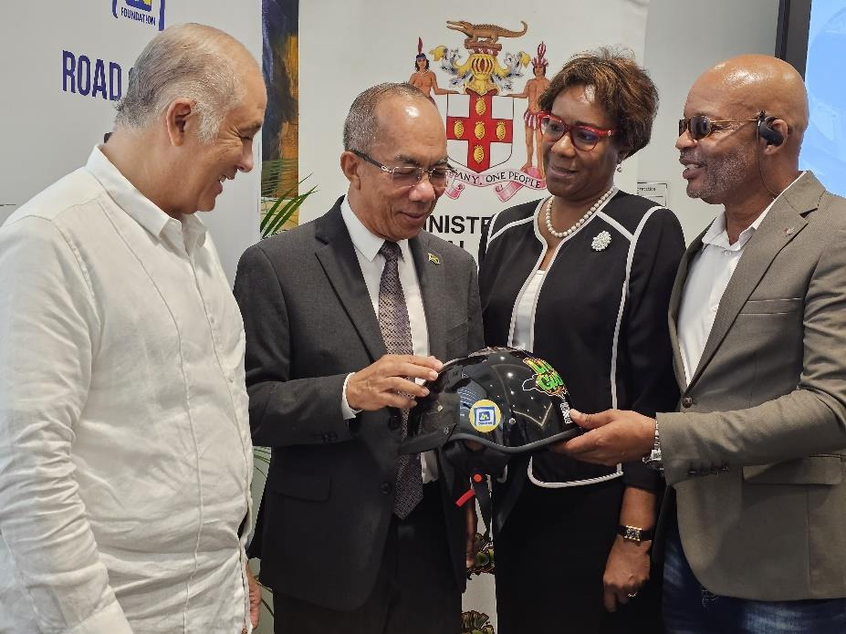 Deputy Deputy Prime Minister and Minister of National Security, the Hon. Dr. Horace Chang, along with Permanent Secretary in the Ministry of National Security, Ambassador Alison Stone Roofe, JN Foundation Chairman, Parris Lyew –Ayee (left) and Conrad Wiggan of the National Helmet Wearing Coalition, admire one of the 2,000 biker helmets donated by the Ministry to the Coalition at a handover ceremony in Kingston earlier today.