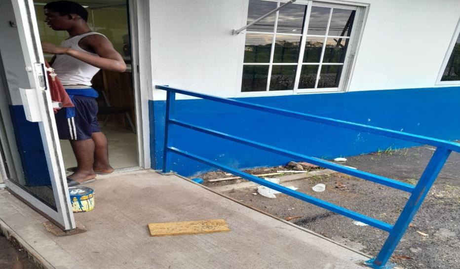 A worker looks on his final work at the newly renovated Exeter Police Station in Race Course, Clarendon, where the wheelchair ramp was among several upgrades made to the facility under the Ministry of National Security’s Project Rebuild, Overhaul and Construct initiative. The project had a price tag of approximately $14.3 million.