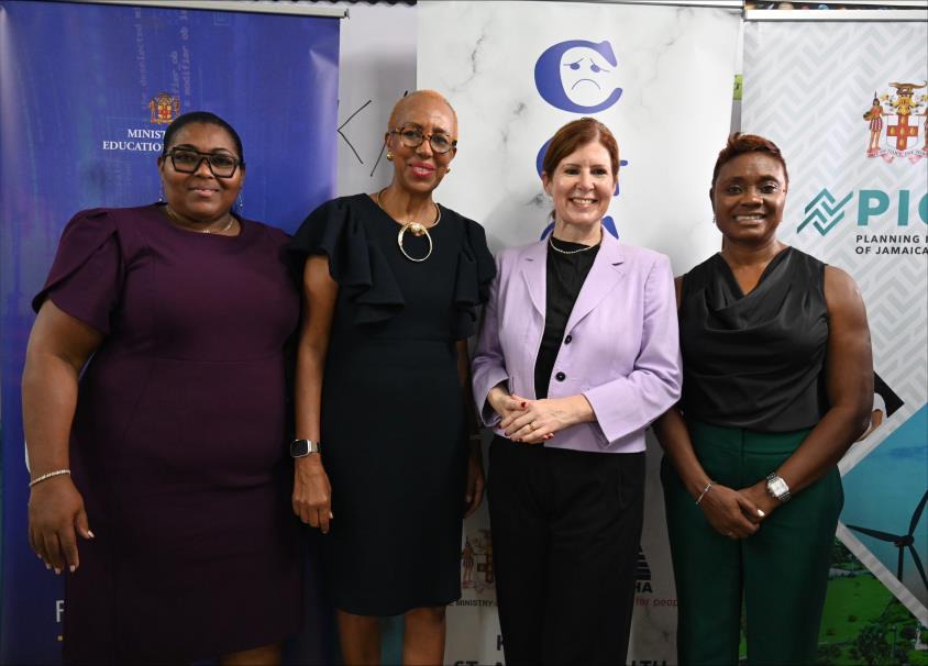 Minister of State in the Ministry of National Security, the Hon. Juliet Cuthbert-Flynn (right) shares a moment with Minister of Education and Youth, the Hon. Fayval Williams (second left), Parliamentary Under-Secretary of State for Latin America and the Caribbean, Baroness Jennifer Chapman of Darlington and Principal of the Edward Seaga Primary School, Shernet Clarke-Tomlinson (left) at the Launch of the UK/Jamaica Violence Prevention Partnership Programme (VPPP), this morning (October 15). The event was he