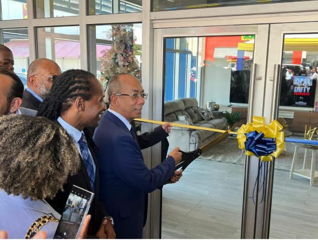 Deputy Prime Minister and Minister of National Security, the Hon. Dr. Horace Chang participates in a ribbon cutting with Chief Executive Officer of COURTS Jamaica, Mr. Mario Siman which signifies the opening of its newest outlet in Portmore Pines, St. Catherine on Wednesday, October 11, 2023. Looking on is Minister of State in the Ministry of Foreign Affairs and Foreign Trade, the Hon. Alando Terrelonge. The COURTS Portmore Pines marks the 29th outlet to be opened in Jamaica.