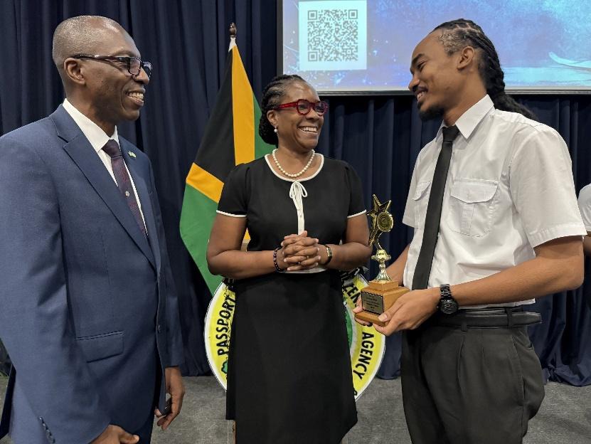 Permanent Secretary in the Ministry of National Security, Ambassador Alison Stone Roofe (centre) engages with Chief Executive Officer of the Passport, Immigration and Citizenship Agency (PICA), Garth Williams (left) and recipient of the Best Overall Performance Award and Valedictorian, Andrae Chen during PICA’s Immigration Graduation Ceremony on Thursday (August 14). The ceremony, held at the Jamaica Defence Force Caribbean Military Academy in Kingston, saw 28 new immigration officers being enlisted to furt
