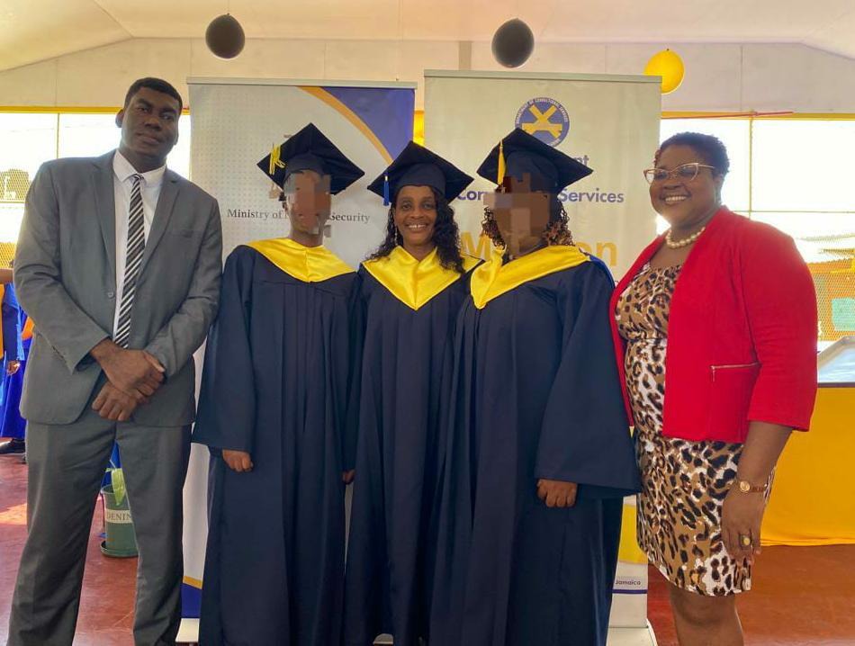 Chief Technical Director in the Ministry of National Security, Shauna Trowers (right) and Acting Commissioner of Corrections in the Department of Correctional Services, Dr. Marc Thomas (left) share a moment with two inmates and Correctional Officer, Yvette Robinson Cohen who were recognised for attaining an Associate Degree in Business Administration from the University of the Commonwealth Caribbean. The event was held at the South Camp Adult Correctional Centre on Thursday, November 30, where fifty inmates