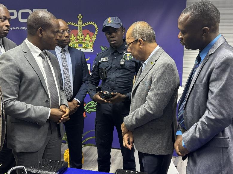 Deputy Prime Minister and Minister of National Security, the Hon. Dr Horace Chang (2nd right), Chief Technical Director, Delroy Simpson (1st right), Commissioner of Police, Dr. Kevin Blake (1st left) and Assistant Commissioner of Police, Clifford Chambers are all engaged as Constable Shawayne Mills explains the use of one of the portable radios which were handed over to the Jamaica Constabulary Force on Wednesday (May 14) during a ceremony at the Commissioner’s Office in Kingston.