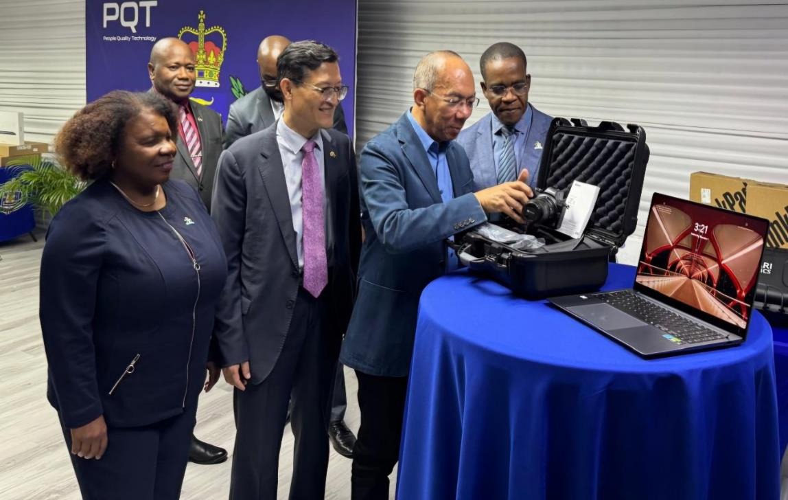 Deputy Prime Minister and Minister of National Security, the Hon. Dr Horace Chang (2nd Right), Chief Technical Director, Ministry of Foreign Affairs and Foreign Trade, Ambassador Sharon J. Miller, (Left), Charge d’ Affairs, Republic of Korea, Jin-Wook Kim and Commissioner of Police, Dr. Kevin Blake (Right), view one of the thirty forensic cameras donated by the Republic of Korea to aid Jamaica’s public safety and security thrust, at the Handover Ceremony of 203 technology devices in Kingston earlier today (