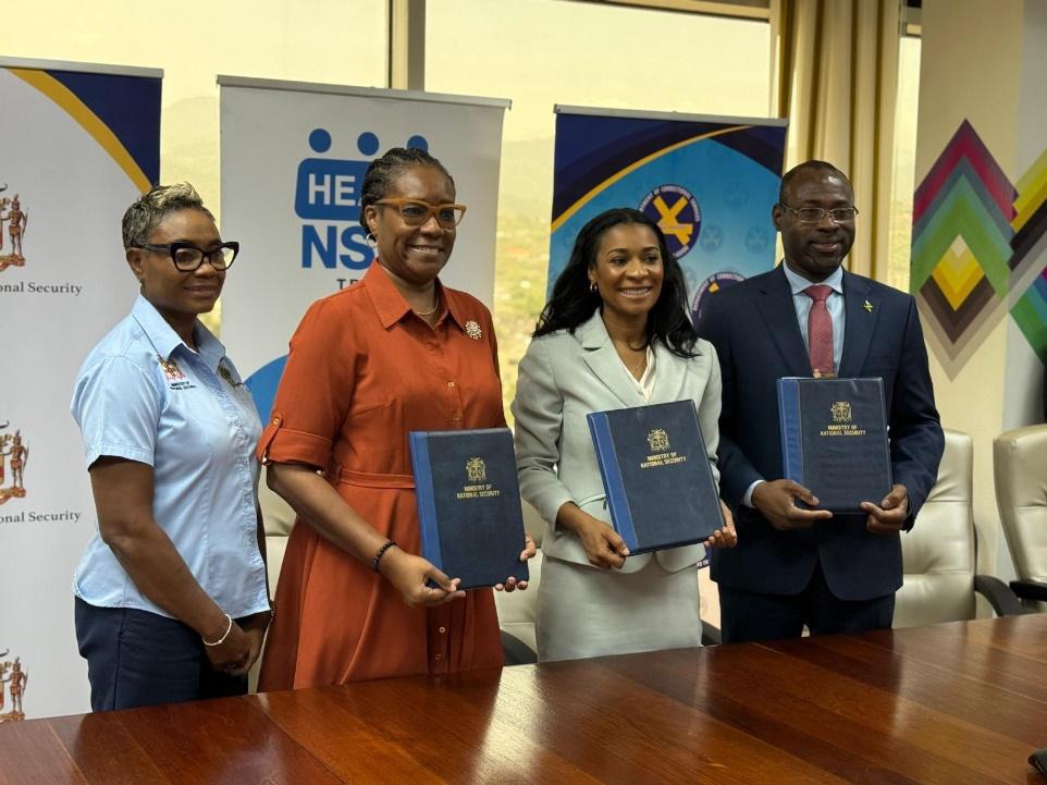 Minister of State in the Ministry of National Security, the Hon. Juliet Cuthbert-Flynn (left) joins Permanent Secretary in the Ministry of National Security, Ambassador Alison Stone Roofe (2nd left) in celebrating the signing of an Memorandum of Understanding to establish a framework to provide training and assessment services to inmates, wards and correctional officers in the Department of Correctional Services. Managing Director for the HEART/NSTA Trust, Dr. Taneisha Ingleton and Commissioner of Correctio