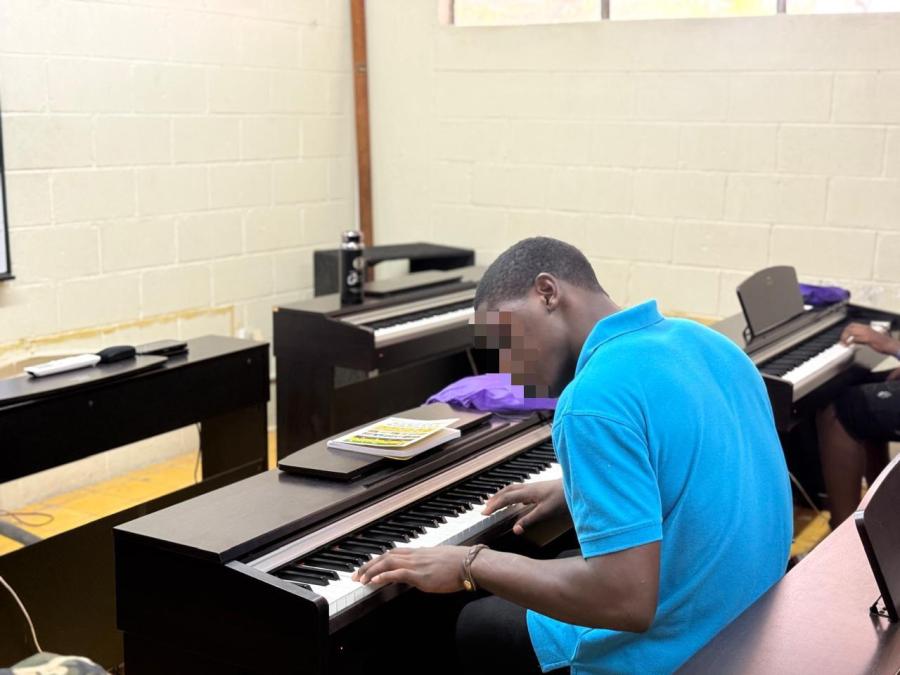 Talent meets opportunity as a LIV GUD Jingle Competition winner explores his musical abilities alongside an instructor from the Edna Manley College of the Visual and Performing Arts in July 2026.